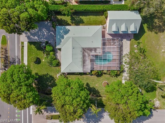 an aerial view of a house with garden space and street view