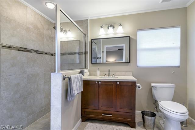 737 Mooring Line Drive Naples, FL 34102 - Photo 11 of 24 a bathroom with a toilet a sink and mirror