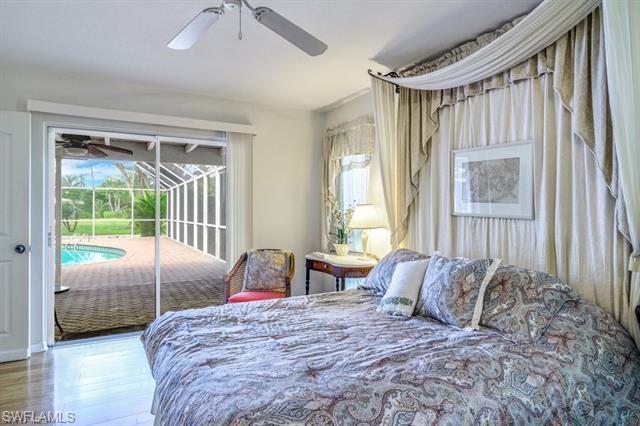 737 Mooring Line Drive Naples, FL 34102 - Photo 19 of 24 a bedroom with a bed and a large window