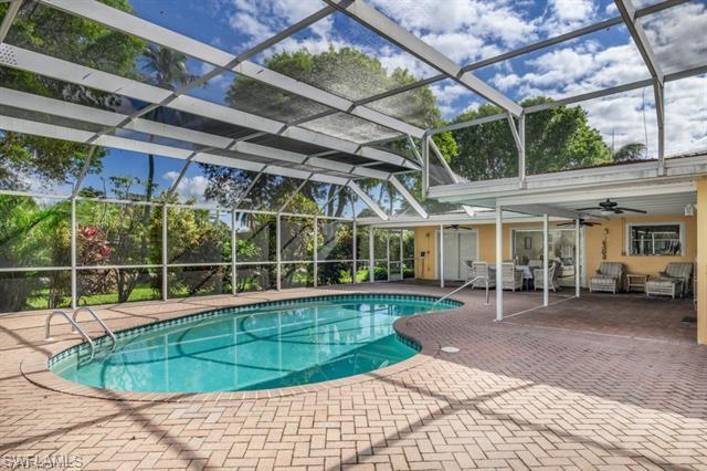 737 Mooring Line Drive Naples, FL 34102 - Photo 5 of 24 a view of a swimming pool with a patio