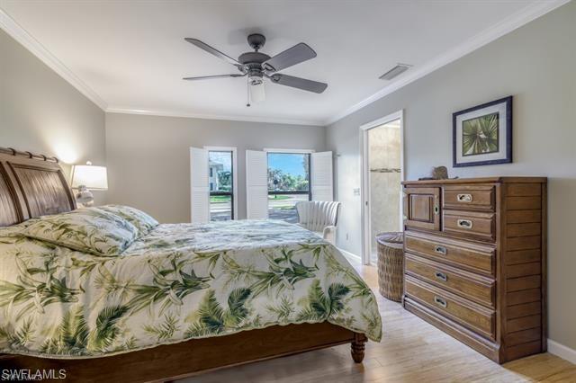 737 Mooring Line Drive Naples, FL 34102 - Photo 10 of 24 a bedroom with a bed and a dresser