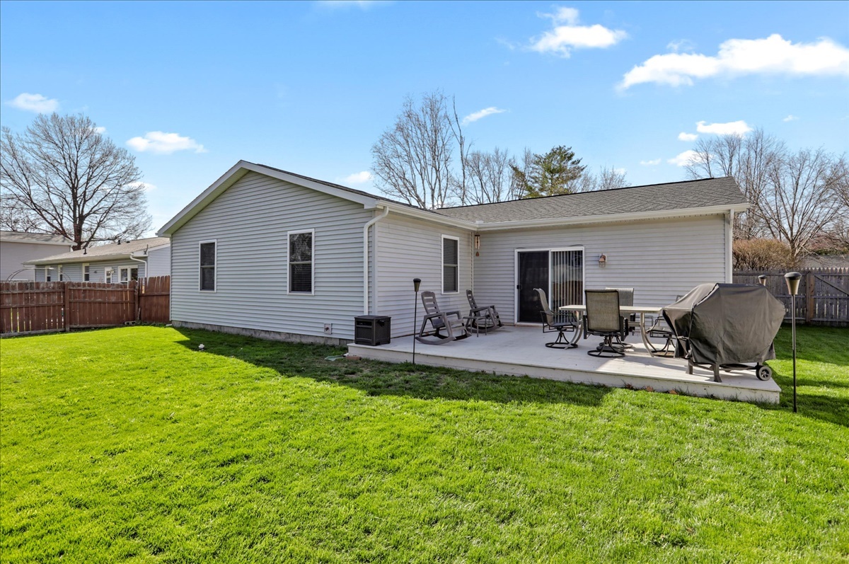 2302 Branch Road Champaign, IL 61821 - Photo 5 of 19 a view of a backyard with table and chairs under an umbrella