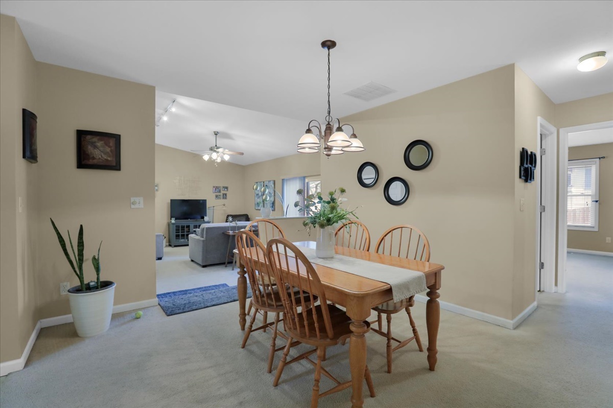 2302 Branch Road Champaign, IL 61821 - Photo 9 of 19 a view of a dining room and kitchen with furniture and a chandelier