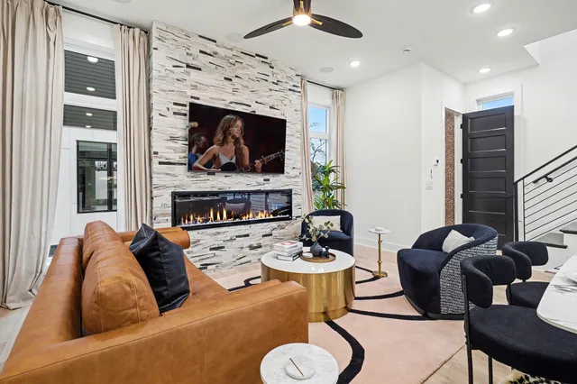 a living room with furniture a fireplace and a flat screen tv