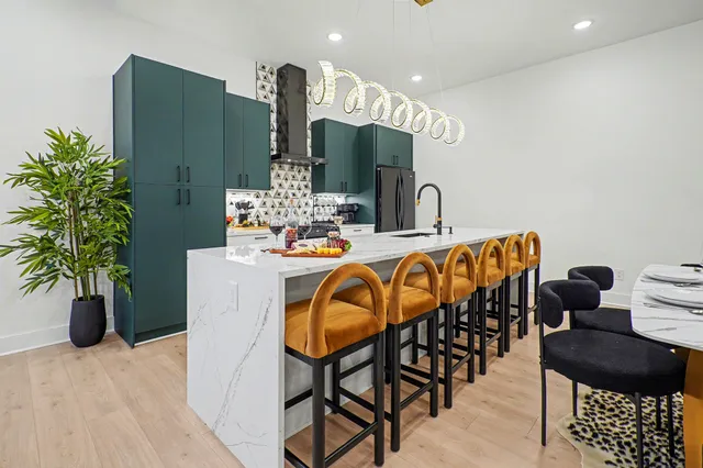 a dining room with furniture and wooden floor