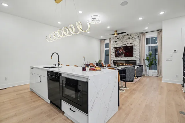 a view of kitchen with sink microwave and stove