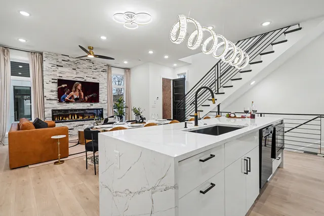a kitchen with stainless steel appliances kitchen island granite countertop a sink and a refrigerator