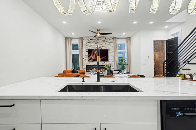 a view of kitchen island a sink and a refrigerator