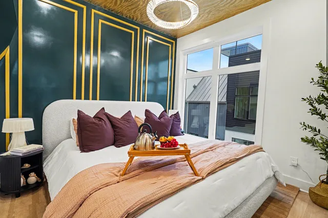 a bedroom with a bed and a mirror