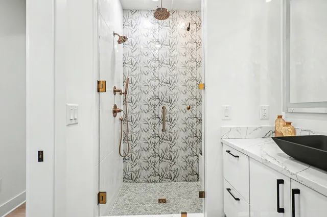 a bathroom with a shower and a sink