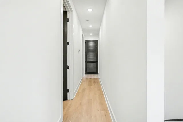 a view of a hallway with wooden floor