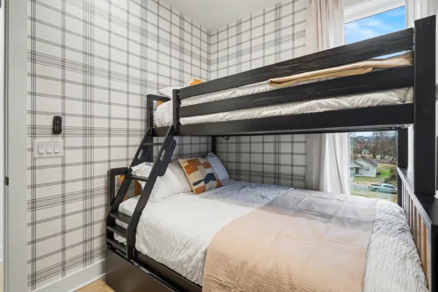 a bedroom with a bed and a window