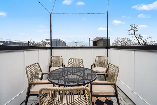 a view of a chair and table in the balcony