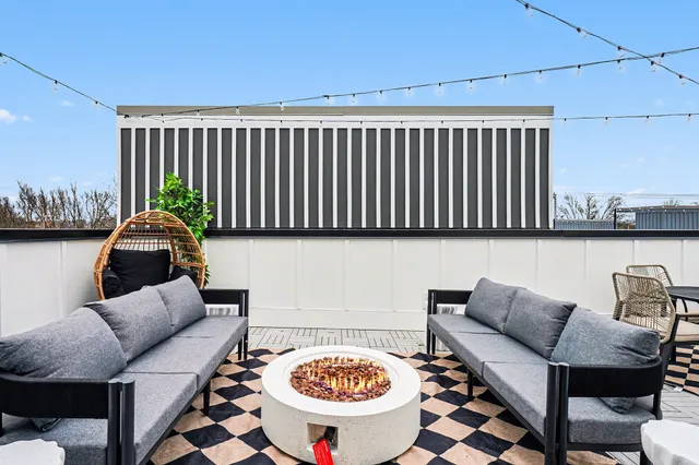 a living room with furniture a rug and a window
