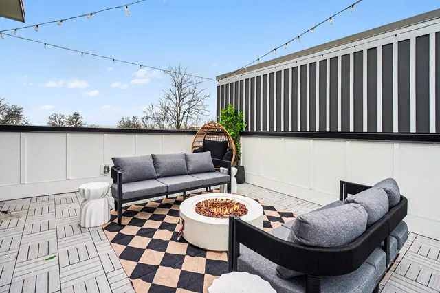 a balcony with table and chairs