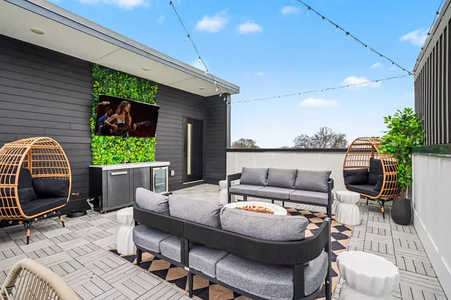 a outdoor living space with furniture and a fireplace