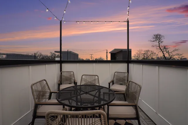 a table and chairs in the balcony