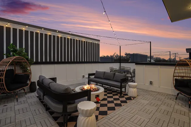 a backyard of a house with glass top table and chairs