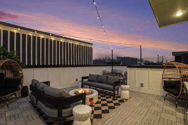 a view of balcony with furniture and a potted plant