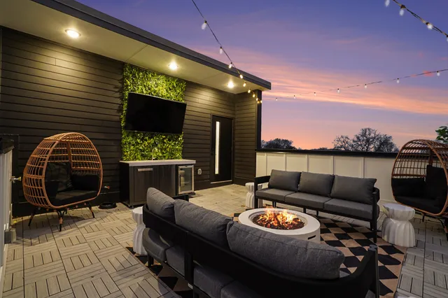a living room with furniture a flat screen tv and a floor to ceiling window