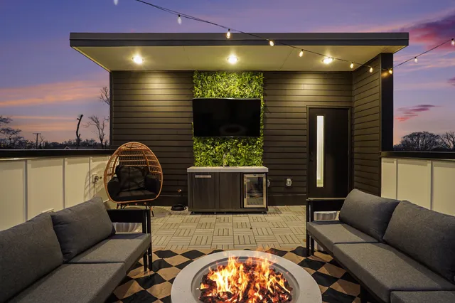 a living room with furniture a flat screen tv and kitchen view