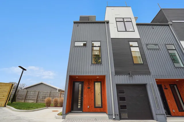 a front view of a house with large windows