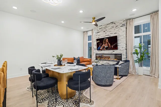 a view of a livingroom with furniture a flat screen tv and a fireplace