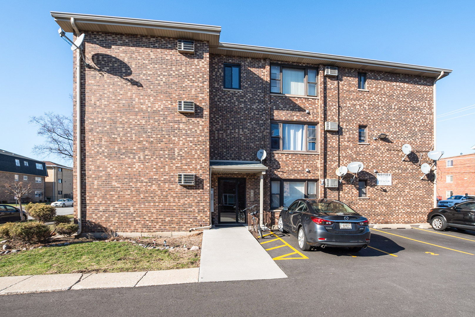 a car parked in front of a brick building