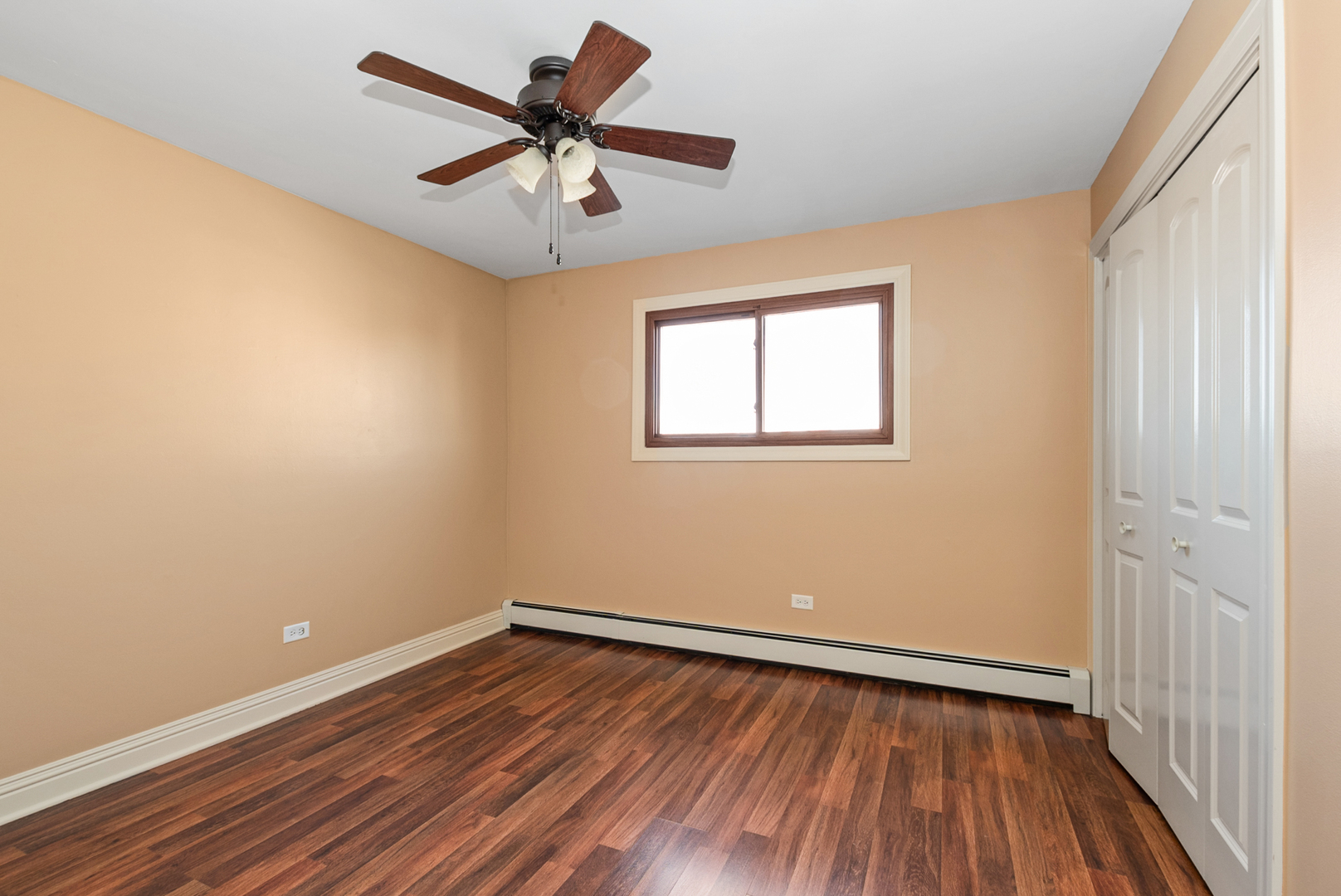 10625 Parkside Avenue, Unit 8 Chicago Ridge, IL 60415 - Photo 12 of 16 wooden floor in an empty room with a window