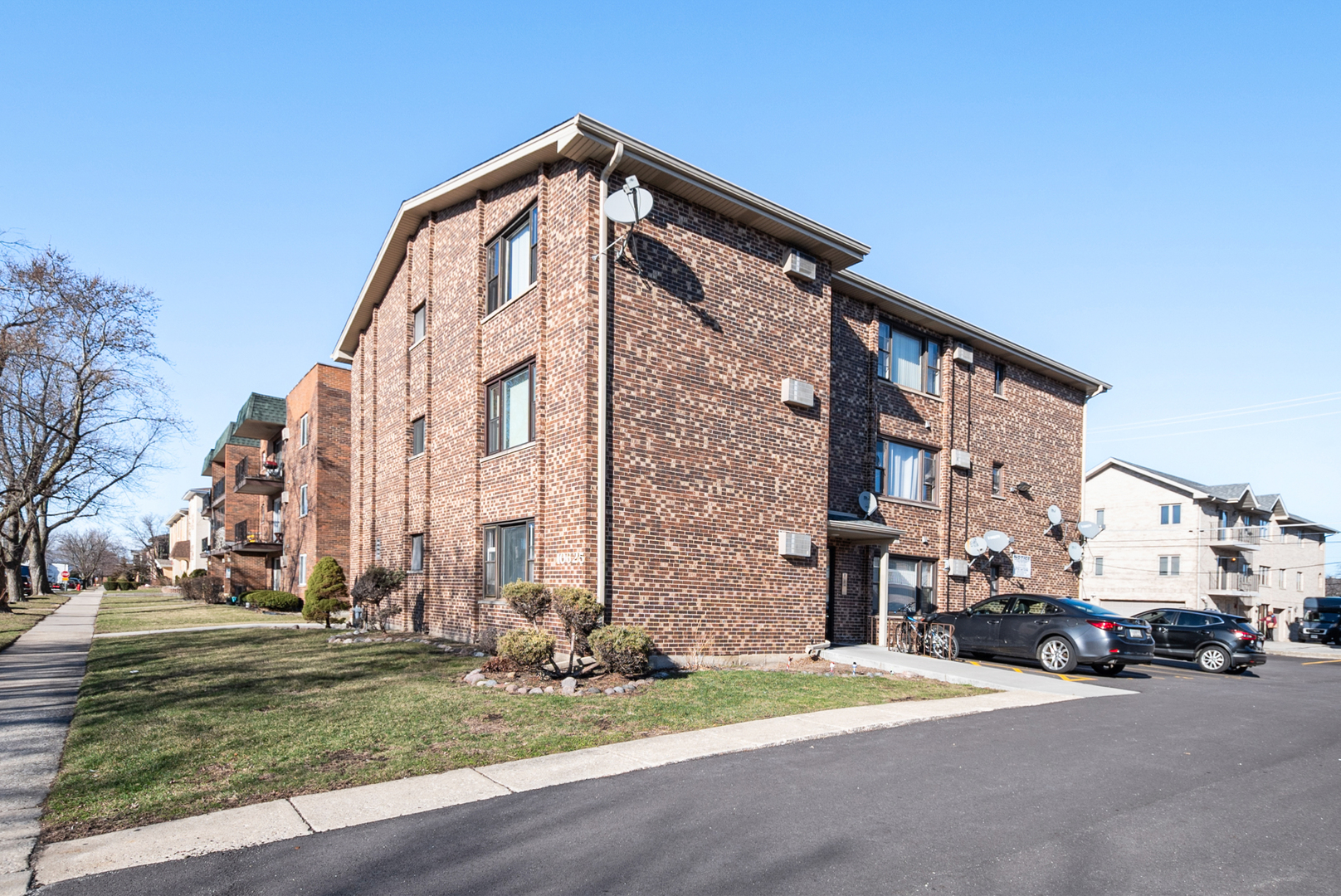 10625 Parkside Avenue, Unit 8 Chicago Ridge, IL 60415 - Photo 16 of 16 a front view of a building with parked cars