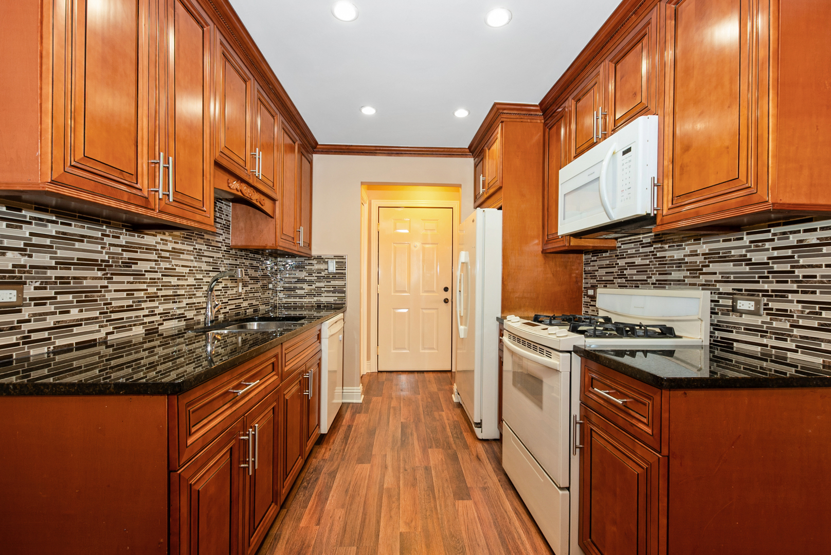 10625 Parkside Avenue, Unit 8 Chicago Ridge, IL 60415 - Photo 5 of 16 a kitchen with stainless steel appliances granite countertop a stove a sink and a refrigerator