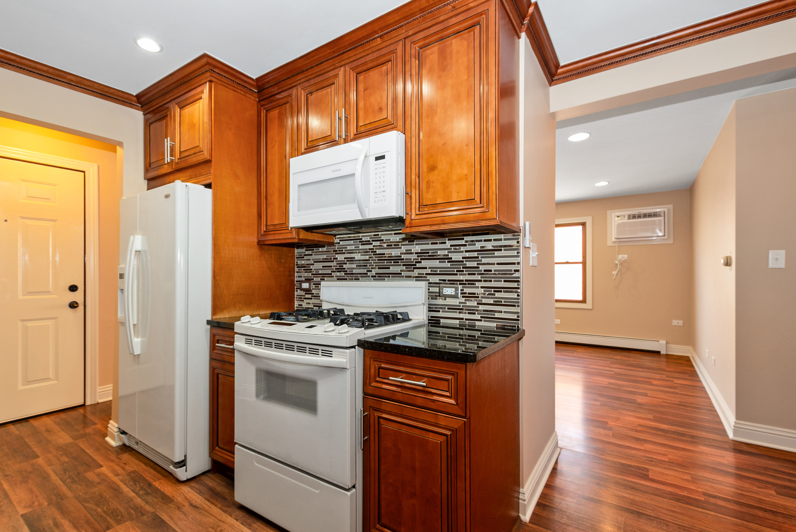 10625 Parkside Avenue, Unit 8 Chicago Ridge, IL 60415 - Photo 6 of 16 a kitchen with stainless steel appliances granite countertop a stove and a refrigerator