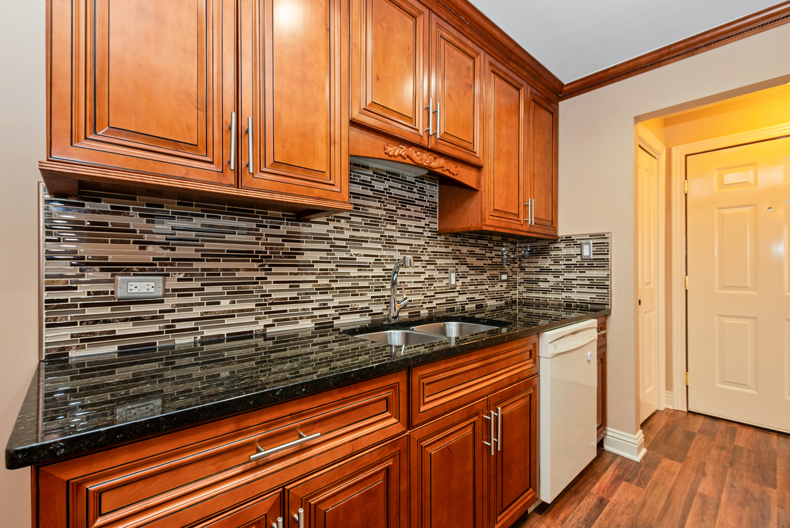 10625 Parkside Avenue, Unit 8 Chicago Ridge, IL 60415 - Photo 7 of 16 a kitchen with wooden cabinets and a wooden floor