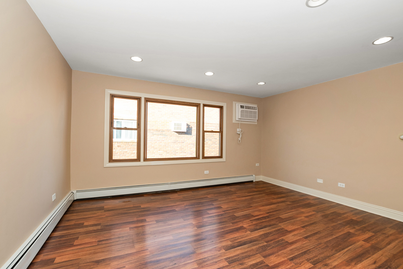 10625 Parkside Avenue, Unit 8 Chicago Ridge, IL 60415 - Photo 10 of 16 wooden floor in an empty room with a window