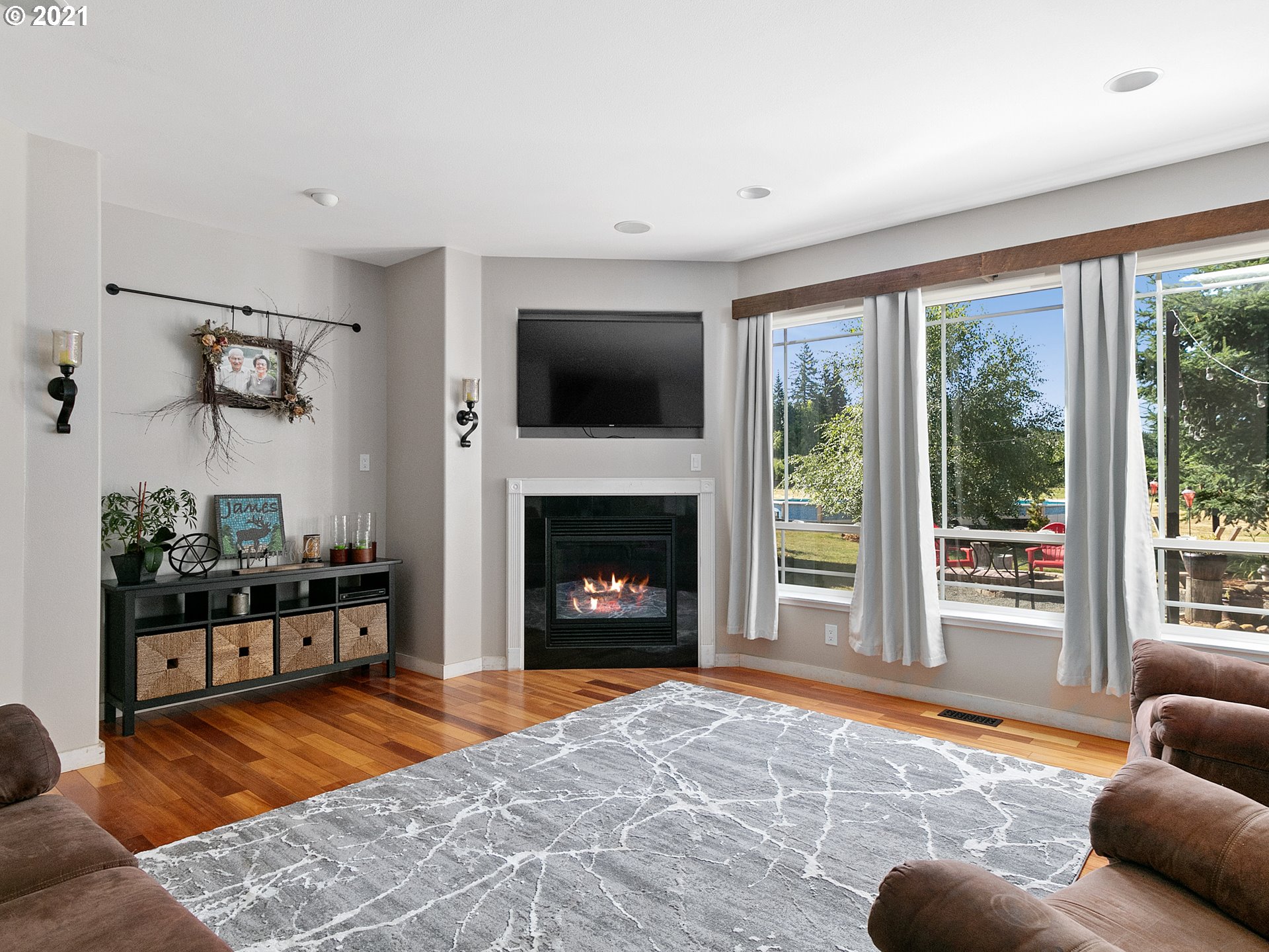 35412 Southeast Shade Tree Lane Estacada, OR 97023 - Photo 11 of 32 a living room with furniture a flat screen tv and a fireplace