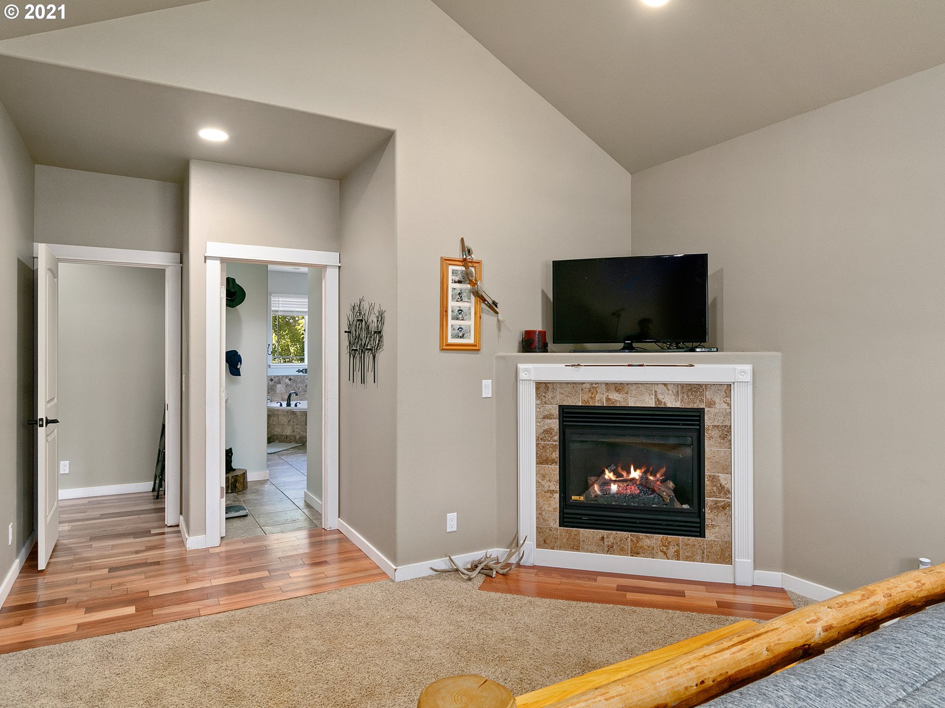 35412 Southeast Shade Tree Lane Estacada, OR 97023 - Photo 17 of 32 a living room with a fireplace and a flat screen tv