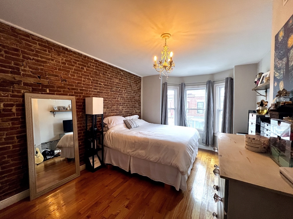 170 I Street, Unit 2 Boston, MA 02127 - Photo 6 of 10 a bedroom with a bed and wooden floor