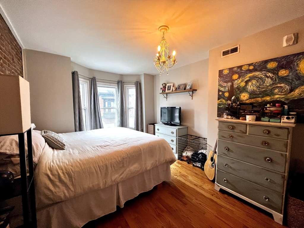 170 I Street, Unit 2 Boston, MA 02127 - Photo 7 of 10 a bedroom with a bed and a flat screen tv