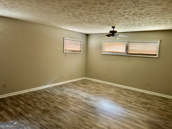 a view of a room with wooden floor