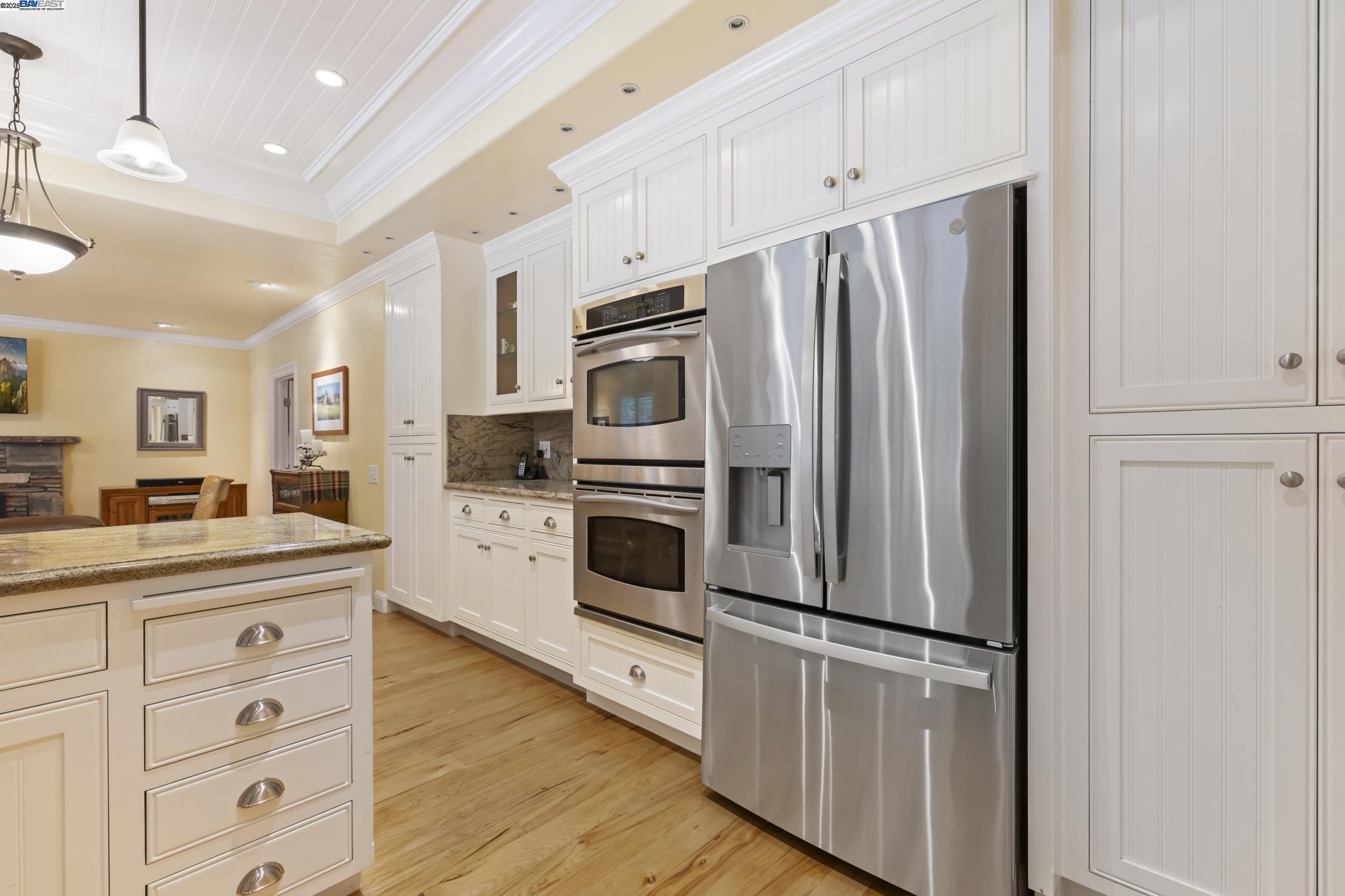 5145 Springdale Avenue Pleasanton, CA 94588 - Photo 17 of 51 a kitchen with cabinets stainless steel appliances and wooden floor