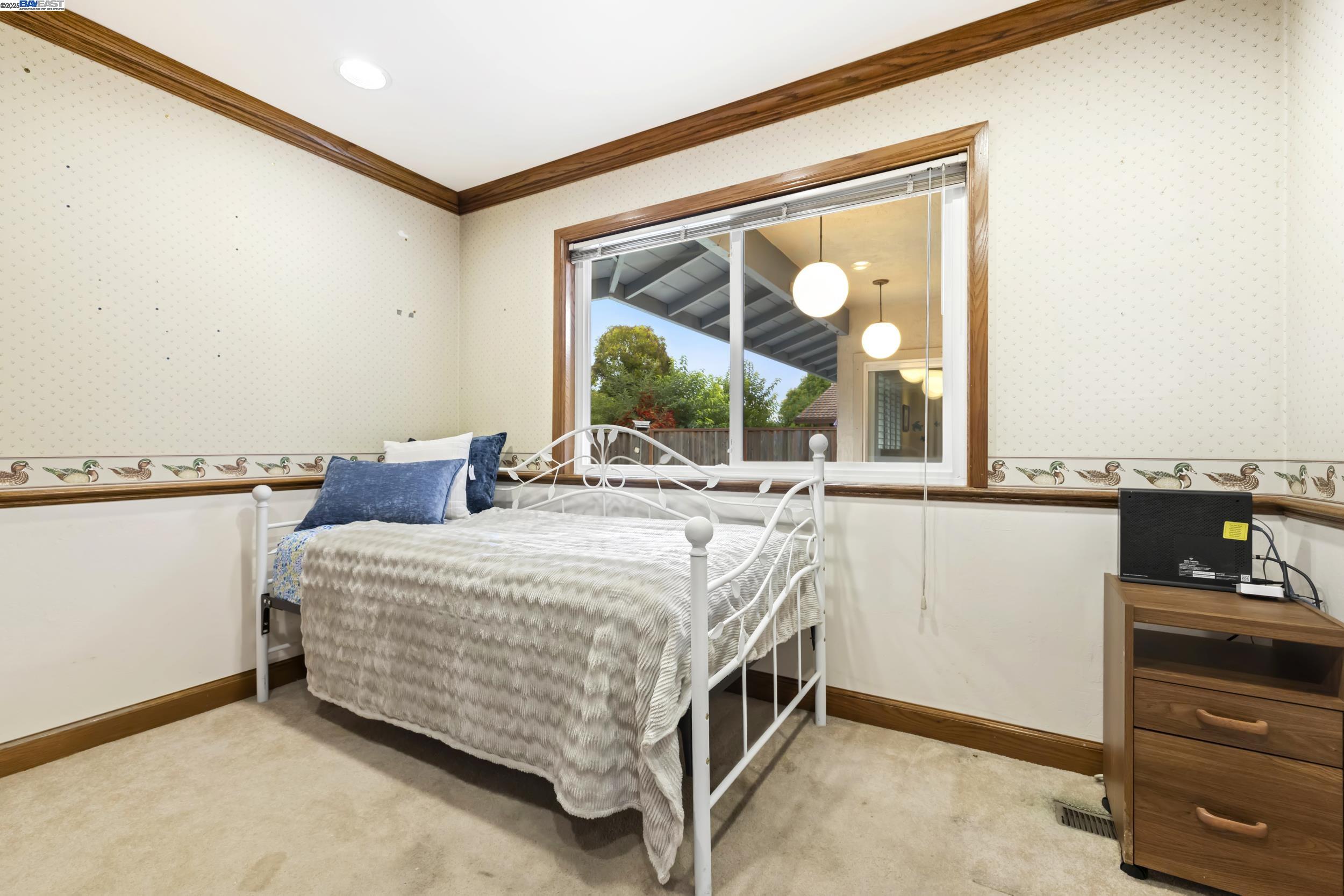 5145 Springdale Avenue Pleasanton, CA 94588 - Photo 21 of 51 a bedroom with a bed and a large window