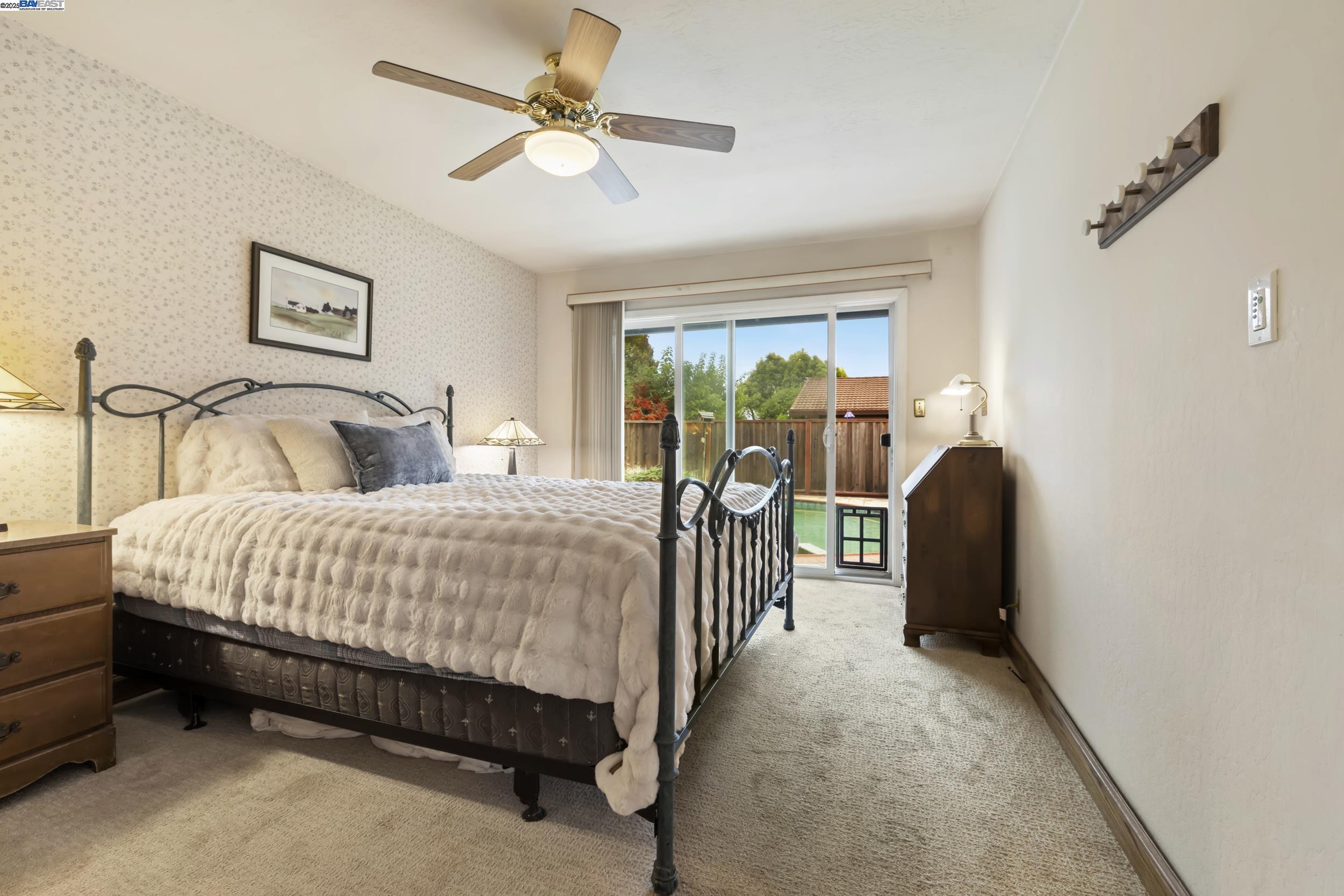 5145 Springdale Avenue Pleasanton, CA 94588 - Photo 23 of 51 a bedroom with a bed and a chandelier