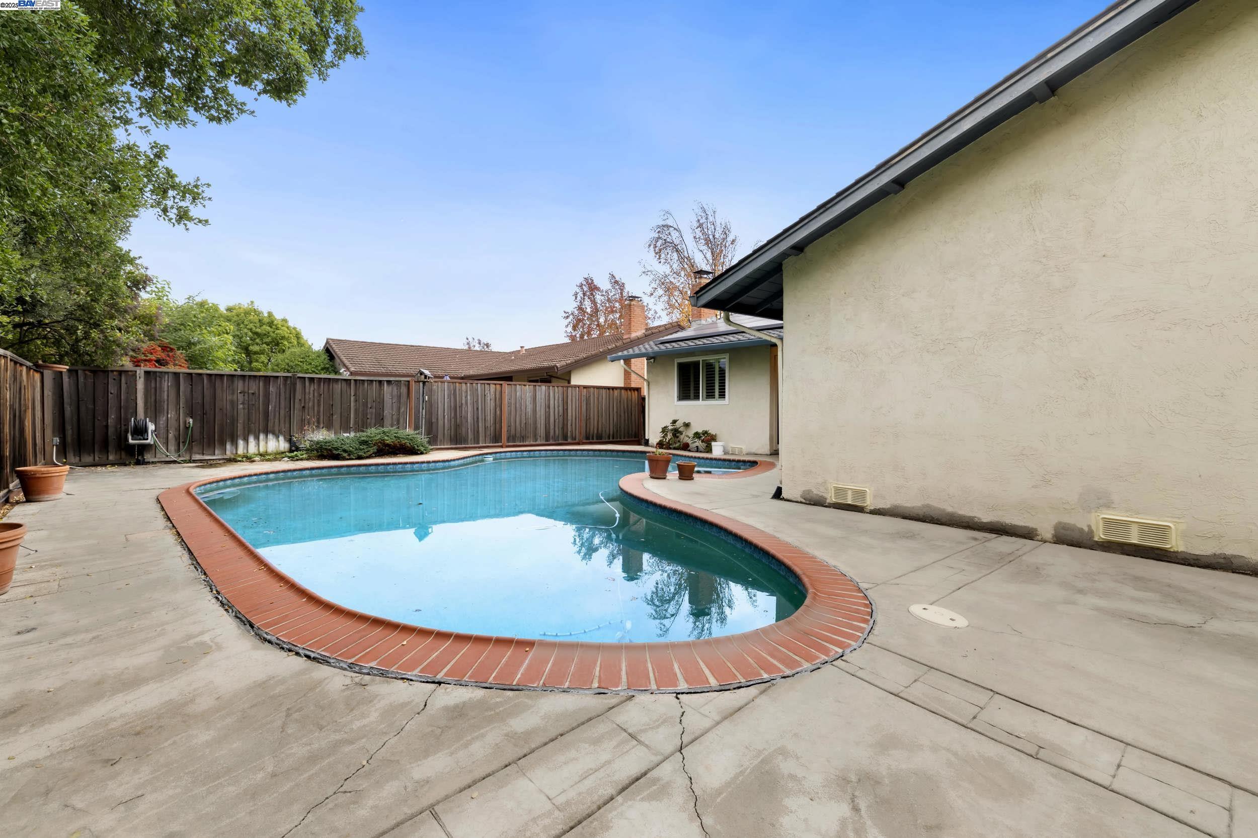 5145 Springdale Avenue Pleasanton, CA 94588 - Photo 36 of 51 a view of a swimming pool with a patio