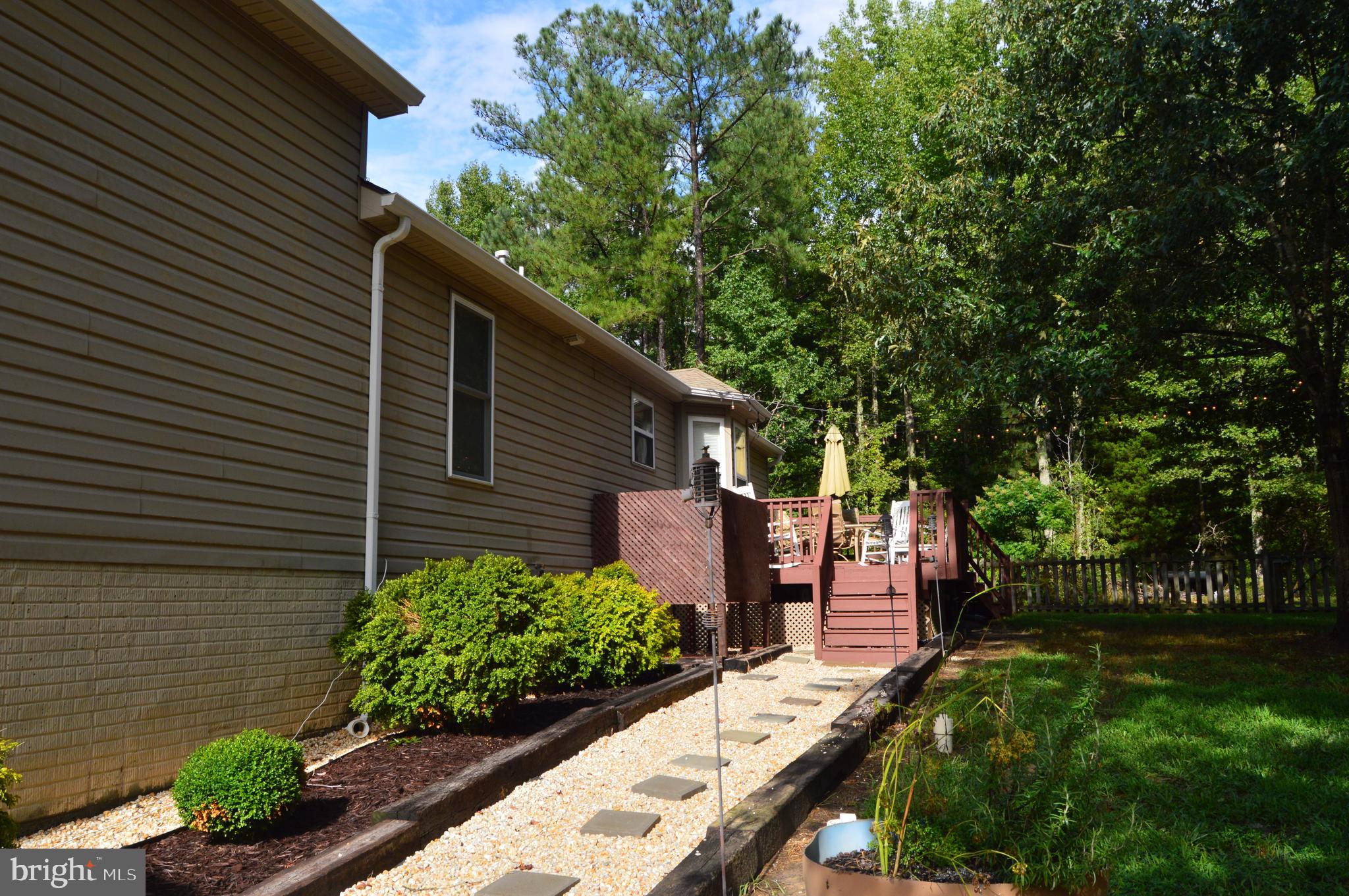 12041 Jesse Lane Ruther Glen, VA 22546 - Photo 11 of 40 Walk way to the outside shower