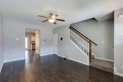 a view of a hallway with wooden floor and workspace
