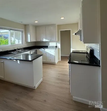 a kitchen with granite countertop white cabinets and a granite counter tops