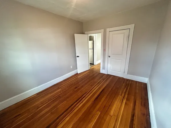 a view of a room with wooden floor and closet