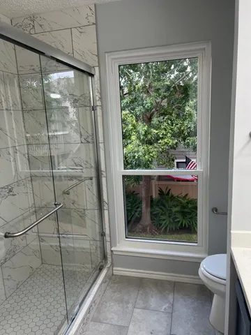 a bathroom with a shower and toilet