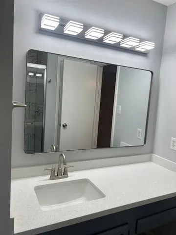 a bathroom with a sink and a mirror