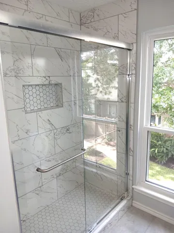 a bathroom with a glass shower door